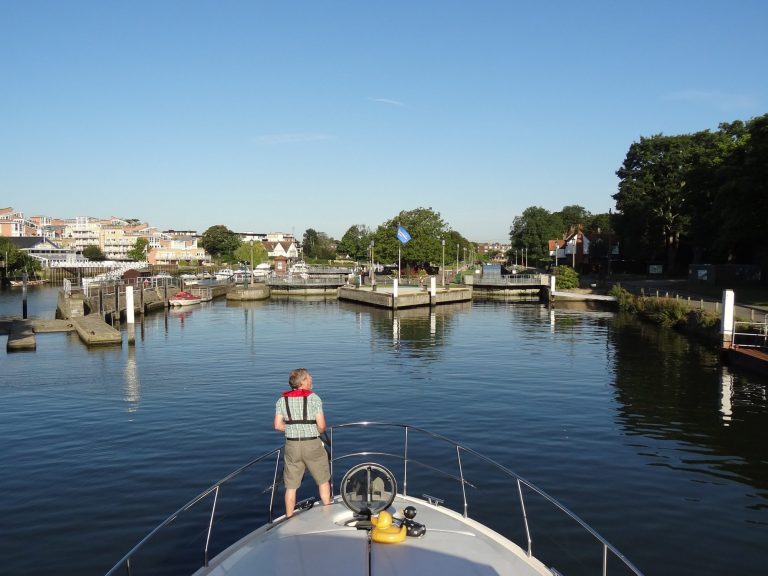 View from the bow of Song and Dance approaching a river lock